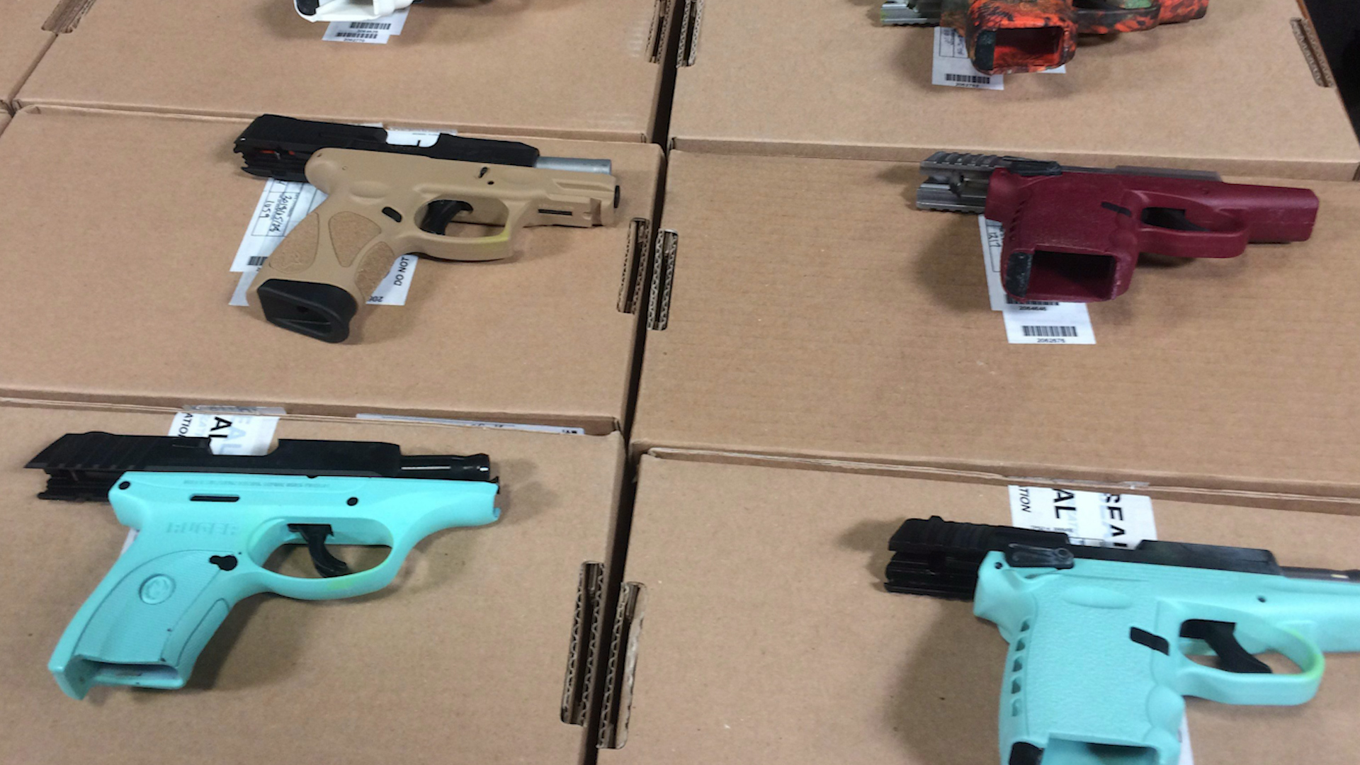 Toronto police show off dozens of guns confiscated in raid